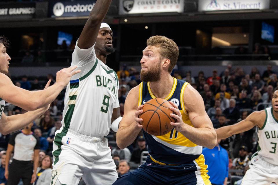 Nov 28, 2021; Indianapolis, Indiana, USA; Indiana Pacers forward Domantas Sabonis (11) moves to shoot the ball while Milwaukee Bucks center Bobby Portis (9) defends in the first quarter at Gainbridge Fieldhouse.