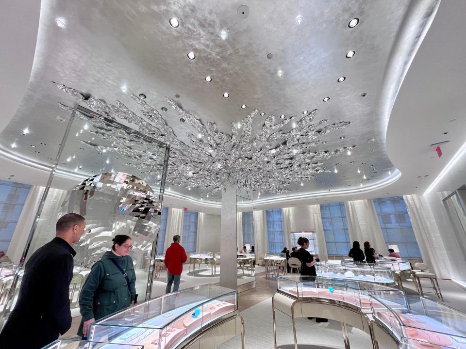 Wide view of interior of Tiffany store with silver foil ceiling art