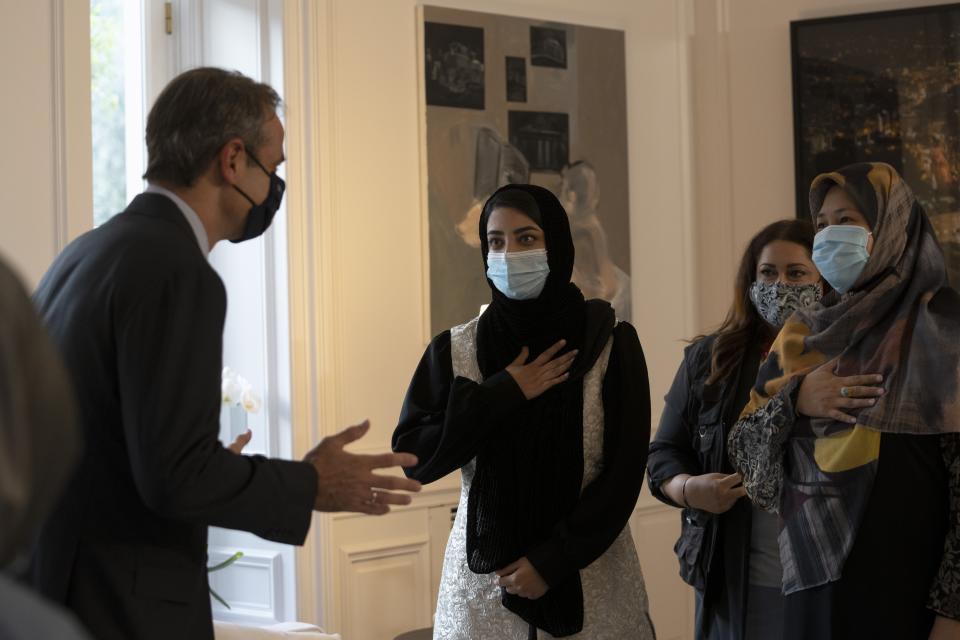 Afghan women attend a meeting with Greece's Prime Minister Kyriakos Mitsotakis at Maximos Mansion, in Athens, Friday, Oct. 15, 2021. The Afghan women, part of a group of judges, lawyers and lawmakers who fled Afghanistan following the Taliban takeover, meet with the Greek Prime Minister before they reach their final destination in the United States. (AP Photo/Petros Giannakouris)