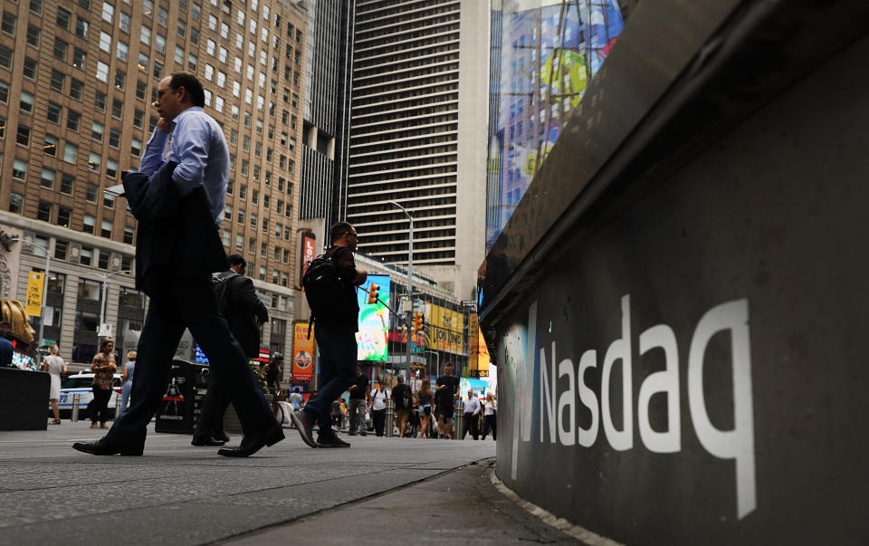 NEW YORK, NY - JULY 30:  People walk by the Nasdaq MarketSite in Times Square on July 30, 2018 in New York City. As technology stocks continued their slide on Monday, the Nasdaq Composite dropped 1.1 percent in afternoon trading with shares of Facebook, Netflix, Amazon and Google-parent Alphabet all declining.  (Photo by Spencer Platt/Getty Images)