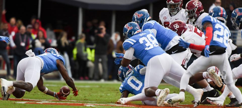 Nov 12, 2022; Oxford, Mississippi, USA;  Ole Miss players dive for an recover a fumble by Alabama wide receiver JoJo Earle (10) at Vaught-Hemingway Stadium. Mandatory Credit: Gary Cosby Jr.-USA TODAY Sports