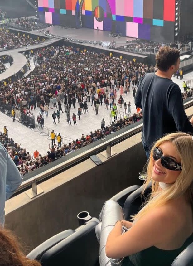 Teenage girl sat at a concert