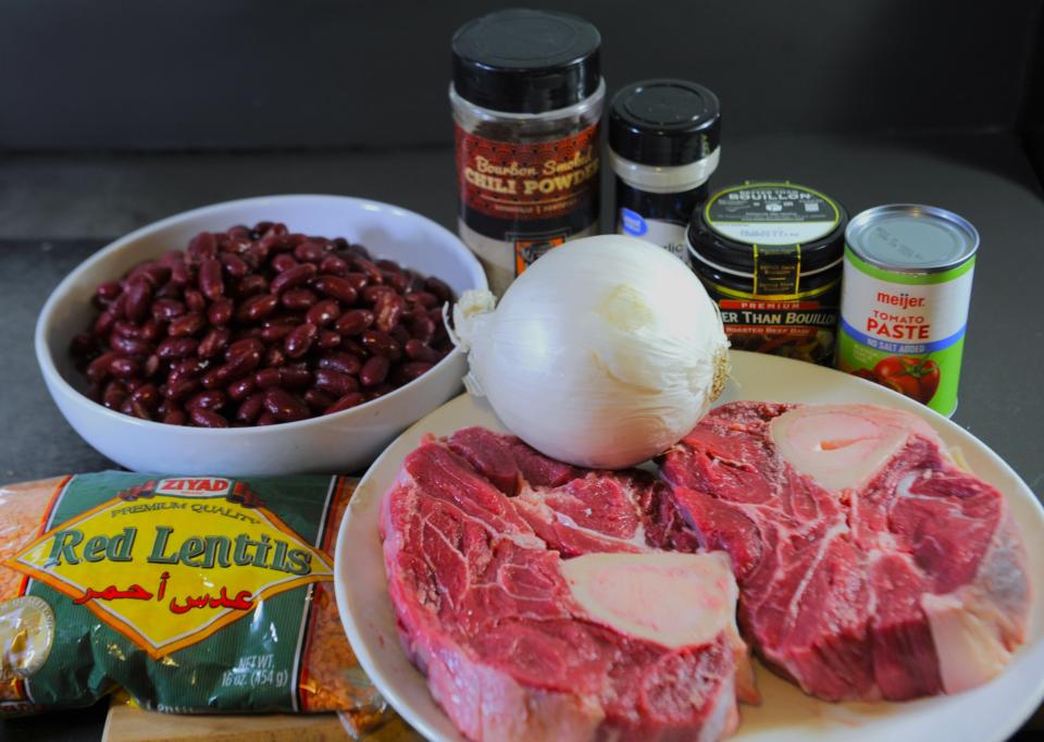 The ingredients for our chili include beef chunks, chili powder and other spices, tomato paste, beef broth, beans and red lentils.