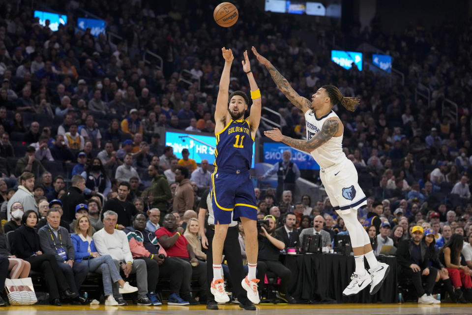 Golden State Warriors forward Klay Thompson (11) shoots a 3-point basket next to Memphis Grizzlies forward Brandon Clarke during the first half of an NBA basketball game in San Francisco, Wednesday, Jan. 25, 2023. (AP Photo/Godofredo A. Vásquez)