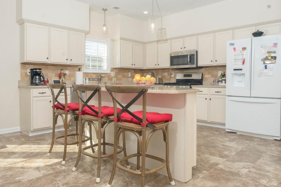 The kitchen was upgraded by a previous owner. An island provides additional seating space for more casual meals.