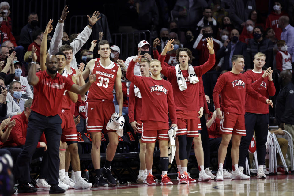 The Wisconsin bench reacts after a 3-point basket against Rutgers during the second half of an NCAA college basketball game Saturday, Feb. 26, 2022, in Piscataway, N.J. (AP Photo/Adam Hunger)