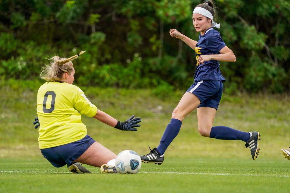 The Pine School's Hannah Squier (18) scores a goal against St. Edward's in a 2-2A regional quarterfinal girls soccer state playoff match Tuesday, Feb. 8, 2022, in Hobe Sound. The Pine School won 2-0.