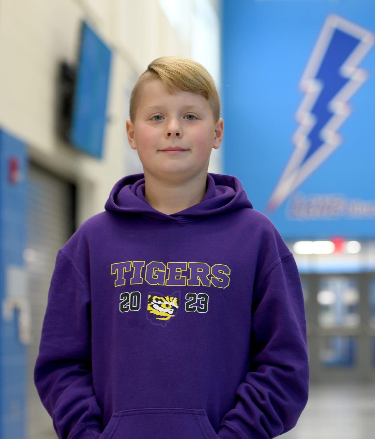 Roman Hess, a sixth-grader at Lake Elementary School, is a Canton Repository Kid of Character for September. He was photographed at school on Tuesday, Sept 12, 2023. The sweatshirt he is wearing is a tribute to his 12-and-younger youth baseball travel team, the Ohio Tigers.