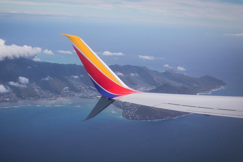 The wing of a Southwest Airlines flight over ocean