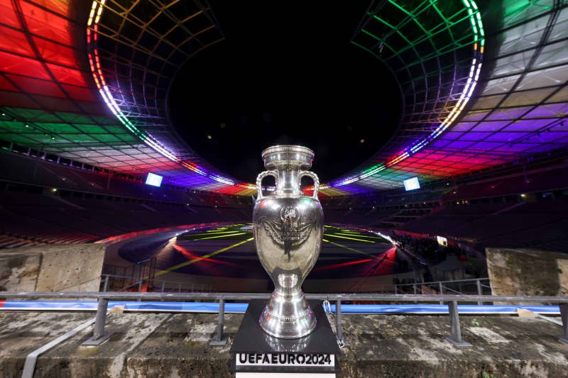 The trophy of the 2024 European Football Championship (UEFA 2024) is displayed at the Olympic Stadium which is illuminated with the colours of the new UEFA Euro 2024 logo. Alexander Hassenstein/Getty-POOL/dpa