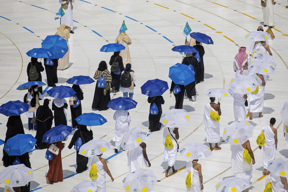 In this photo released by the Saudi Media Ministry, a limited numbers of pilgrims move several feet apart, circling the cube-shaped Kaaba in the first rituals of the hajj, as they keep social distancing to limit exposure and the potential transmission of the coronavirus, at the Grand Mosque in the Muslim holy city of Mecca, Saudi Arabia, Wednesday, July 29, 2020. The hajj, which started on Wednesday, is intended to bring about greater humility and unity among Muslims. (Saudi Media Ministry via AP)