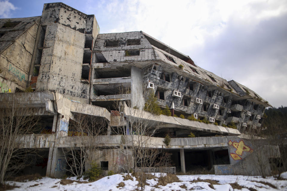 The destroyed Igman Hotel, built to house the competitors of the Sarajevo Winter Olympic Games, on Igman mountain near Sarajevo, Bosnia, Wednesday, Feb. 7, 2024. Sarajevo is paying tribute this week to one of its most glorious moments: the two weeks of February in 1984 when it staged an impeccable Winter Olympic Games. While taking the nostalgic trip down memory lane, Bosnian Olympians say they are looking to the future with hope to again pull off an “apparently impossible feat” and reignite the Olympic flame over Sarajevo in 2032. (AP Photo/Armin Durgut)