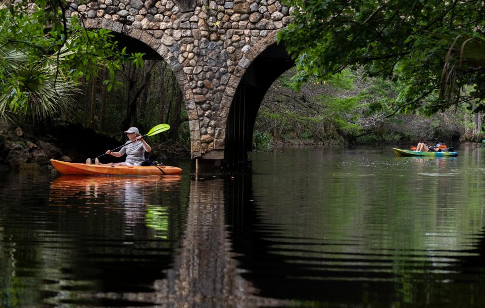 Jan Freeman, left, of Boca Raton, paddles her kayak while her friend, Nancy Huston of Springfield, Illinois, takes a moment to relax before turning in their rental kayaks to Jupiter Outdoor Center in Riverbend Park in Jupiter.