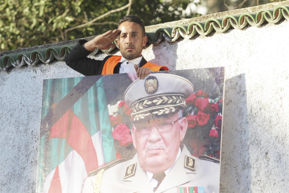 A man gives the military salute during the funeral of late Algerian military chief Gaid Saleh in Algiers, Algeria, Wednesday, Dec. 25, 2019. Algeria is holding an elaborate military funeral for the general who was the de facto ruler of the gas-rich country amid political turmoil throughout this year. (AP Photo/Fateh Guidoum)