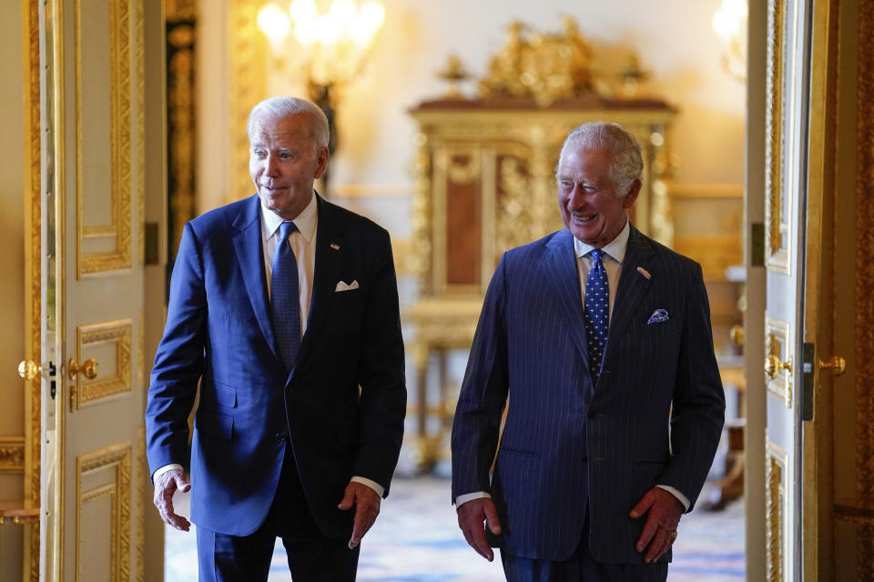 Britain's King Charles III, right, and US President Joe Biden arrive to meet participants of the Climate Finance Mobilisation forum in the Green Drawing Room at Windsor Castle, England, Monday July 10, 2023. (Andrew Matthews/Pool via AP)