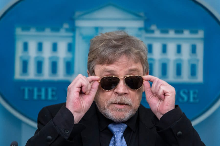 Actor Mark Hamill takes off sunglasses given to him by President Joe Biden, as he joins White House press secretary Karine Jean-Pierre as she speaks with reporters in the James Brady Press Briefing Room at the White House, Friday, May 3, 2024, in Washington. (AP Photo/Alex Brandon)