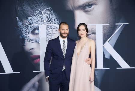 FILE PHOTO - Jamie Dornan (L) and Dakota Johnson pose at the premiere of the film "Fifty Shades Darker" in Los Angeles, California, U.S. on February 2, 2017. REUTERS/Danny Moloshok/File Photo