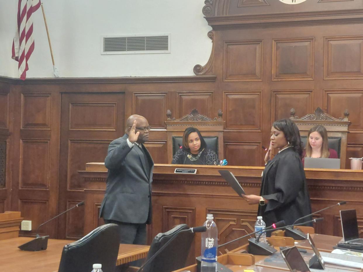 Samuel DeShazior is sworn in as Akron's Ward 1 councilman by Judge Kani Harvey Hightower Monday in City Council chambers.