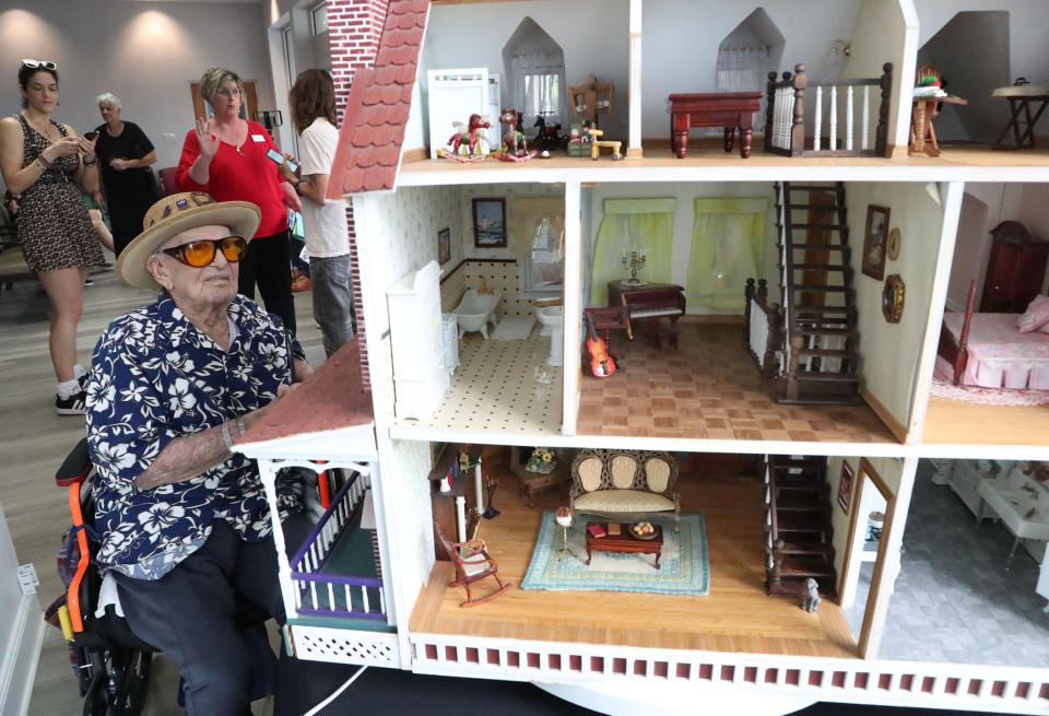 103-year-old World War II veteran Ed Vrona surveys the dollhouse he spent 10 years building with his late wife, Georgie. Vrona has donated the elaborate three-story eight-room house to the Easterseals Autism Center of Excellence in Daytona Beach.