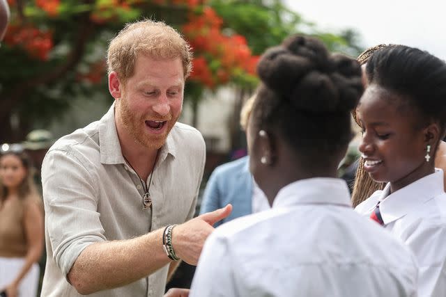 <p>SODIQ ADELAKUN/AFP via Getty</p> Prince Harry meets students in Nigeria