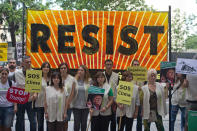 <p>Greenpeace protesters stand in silence with banners outside the U.S. embassy in Madrid, Spain, Friday, June 2, 2017. The protesters gathered at the gates of the United States embassy in the Spanish capital to protest President Donald Trump’s decision to pull the world’s second-largest carbon dioxide emitter out of the Paris climate agreement. Small banners read ‘Climate SOS’ and ‘We’ll go ahead without you’ (AP Photo/Paul White) </p>