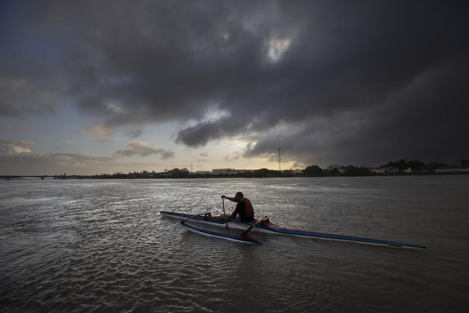 Tahi Nepia, a waka ama (outrigger canoe) paddler and caretaker at a Maori immersion school, travels on the Whanganui River in New Zealand on June 14, 2022. Before venturing out, he makes sure to first ask permission from his ancestors in a prayer, or karakia. It's the top item on his safety list. He says his ancestors inhabit the river and each time he dips his paddle into the water, he touches them. “You are giving them a mihimihi, you are giving them a massage," Nepia says. "That’s how we see that river. It’s a part of us.” (AP Photo/Brett Phibbs)