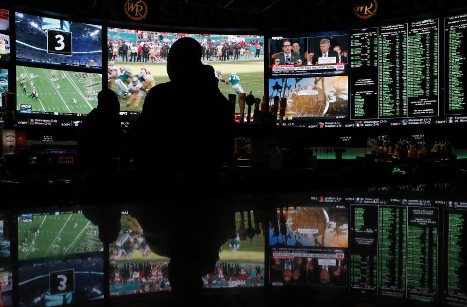 The first public impeachment hearing of President Donald Trump plays on a screen along with sports at the Superbook sports book inside the Westgate casino-hotel Wednesday, Nov. 13, 2019, in Las Vegas. (AP Photo/John Locher)