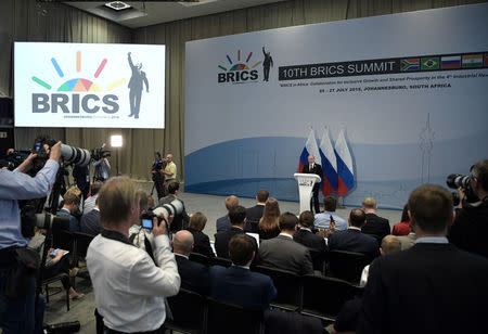 Journalists listen to Russia's President Vladimir Putin during a news conference following the BRICS summit in Johannesburg, South Africa July 27, 2018. Sputnik/Alexei Nikolsky/Kremlin via REUTERS