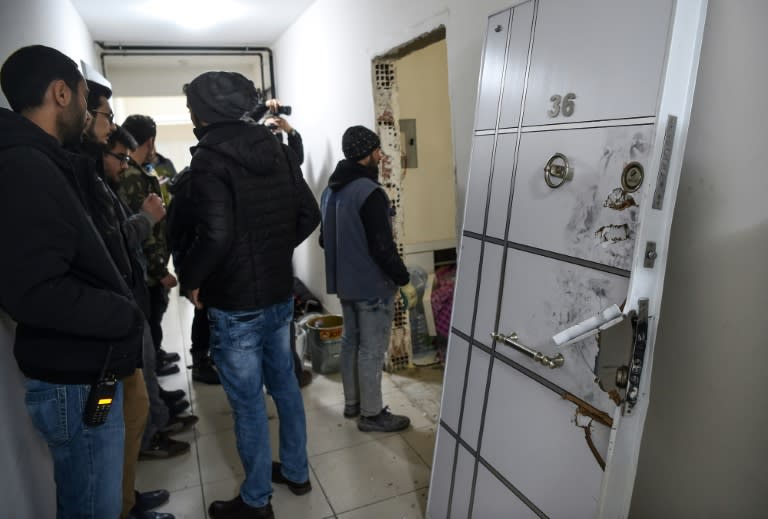 Turkish police officers wait at the apartment where the main suspect in the Reina nightclub rampage was arrested the night before, in Istanbul on January 17, 2017