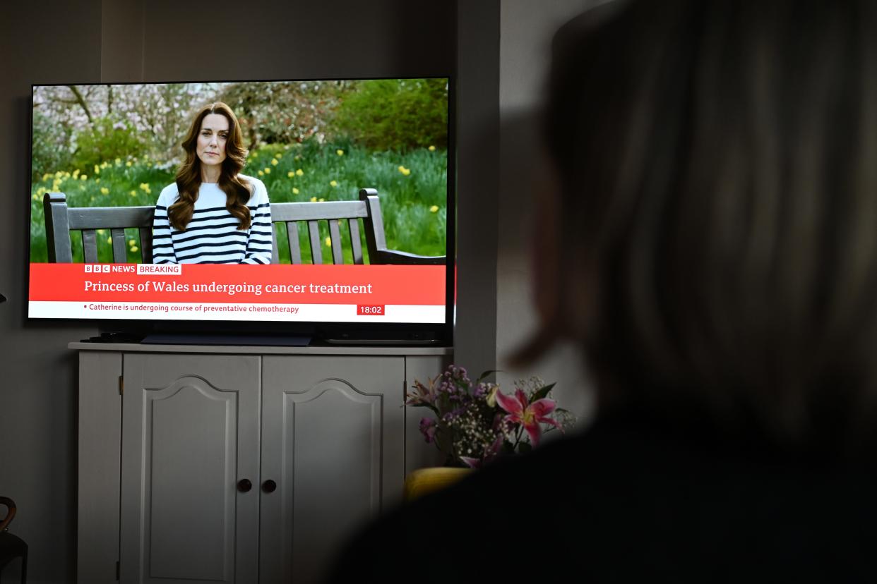 A relative of the photographer watches television, as Catherine, The Princess of Wales, announces that she is receiving a preventative course of chemotherapy for cancer on March 22, 2024, in London. The Princess of Wales had abdominal surgery earlier this year and has revealed that cancer has subsequently been found. She said she has been receiving chemotherapy and asked for privacy for her and her family.
