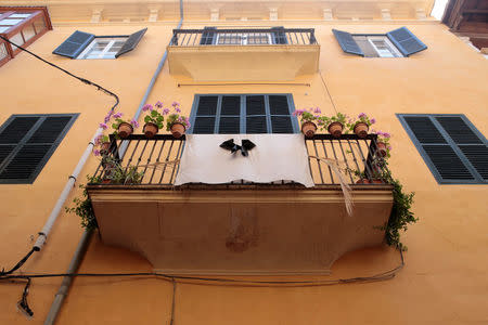 A white sheet with a black ribbon hangs from a balcony in Palma de Mallorca, in the Spanish island of Mallorca, May 23, 2016. REUTERS/Enrique Calvo