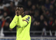 Barcelona forward Ousmane Dembele holds his face during the Champions League round of 16 first leg soccer match between Lyon and FC Barcelona in Decines, near Lyon, central France, Tuesday, Feb. 19, 2019. (AP Photo/Laurent Cipriani)