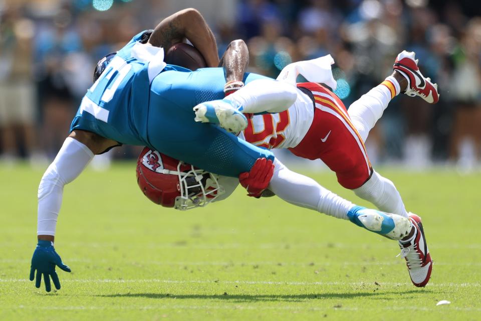 Kansas City Chiefs cornerback Jaylen Watson (35) tackles Jacksonville Jaguars wide receiver Christian Kirk (13) during the first quarter of a NFL football game Sunday, Sept. 17, 2023 at EverBank Stadium in Jacksonville, Fla. [Corey Perrine/Florida Times-Union]