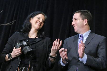 Laura Poitras, (L) and Glenn Greenwald smile as they receive the George Polk Awards in New York, April 11, 2014. REUTERS/Eduardo Munoz