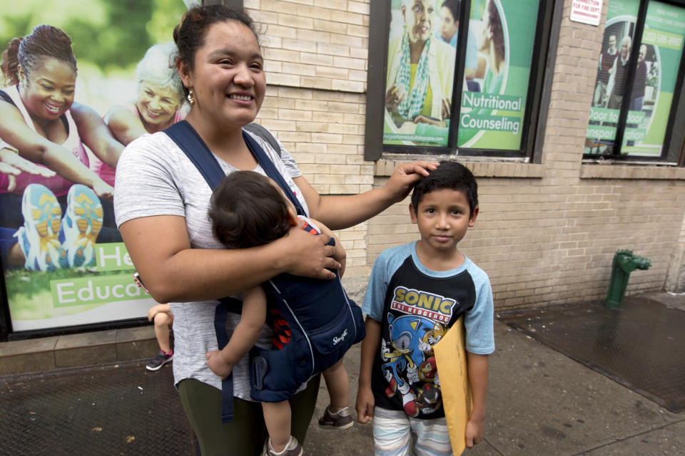 In this Friday, Aug. 3, 2018, photo, Eilyn Carbajal, from Honduras, is reunited with her son Nahun Eduardo Puerto Pineda, then 8, right, at the Cayuga Center, in New York. (AP Photo/Richard Drew)