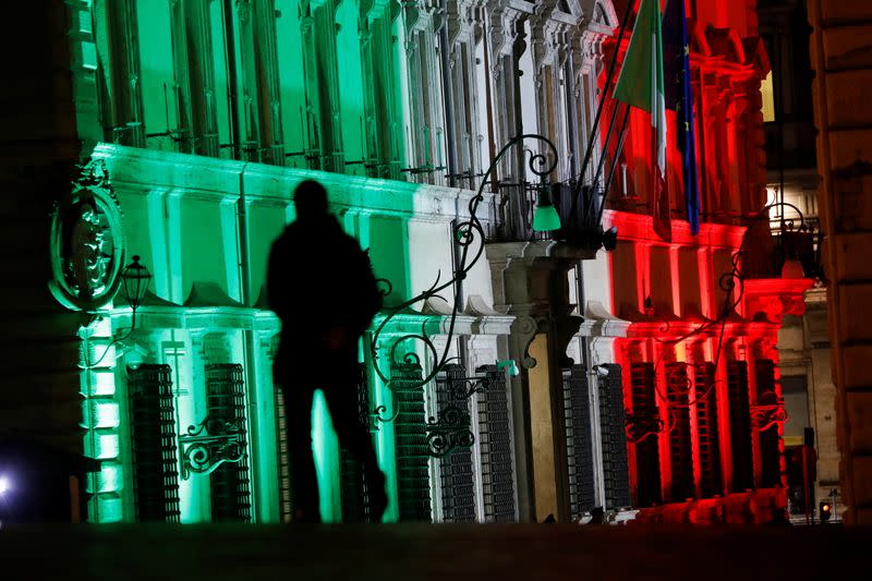 A man walks past the Prime Minister's Office, Chigi Palace, in Rome