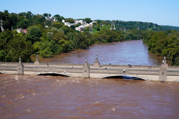 The Schuylkill River exceeds its bank in the Manayunk section of Philadelphia on Thursday in the aftermath of downpours and high winds from the remnants of Hurricane Ida. (Photo: via Associated Press)