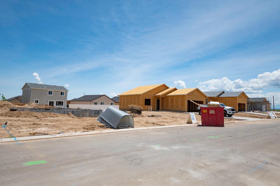 Crews work on the construction of multiple homes in the expansion of Pueblo's South Pointe neighborhood on Wednesday.