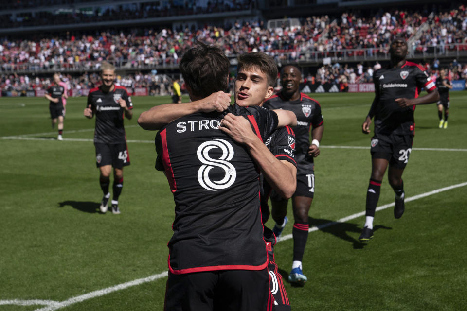 DC United's Jared Stroud (8) is congratulated after scoring a goal during the first half of an MLS soccer match against Inter Miami at Audi Field, Saturday, March 16, 2024, in Washington. (AP Photo/Nathan Howard)