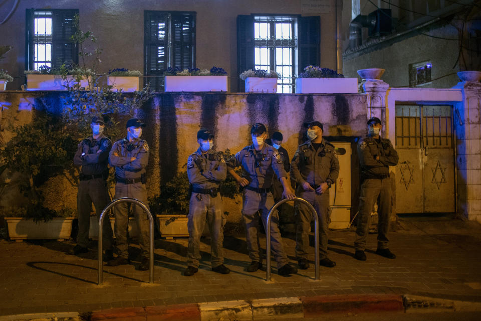 Israeli policemen stand guard at the entrance of a Jewish nationalist religious group's house in the Arab neighborhood of Jaffa, in Tel Aviv, Israel, Saturday, April 24, 2021. Historic Jaffa's rapid gentrification in recent years is coming at the expense of its mostly Arab lower class. With housing prices out of reach, discontent over the city’s rapid transformation into a bastion for Israel’s ultra-wealthy is reaching a boiling point. (AP Photo/Ariel Schalit)