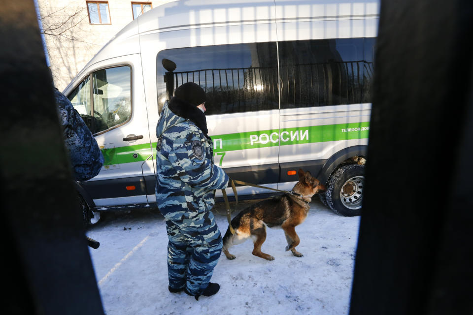 A Police officer patrols an area around a court during the trial against Russian opposition leader Alexey Navalny in Moscow, Russia, on Tuesday, Feb. 16, 2021. Navalny is accused of defaming a World War II veteran who was featured in a video last year advertising constitutional amendments that allowed an extension of President Vladimir Putin's rule. (AP Photo/Alexander Zemlianichenko)