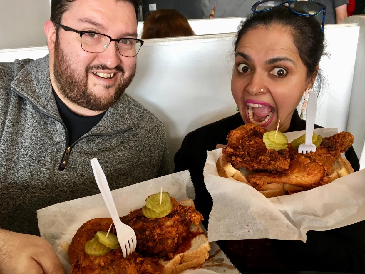 Celebrity chef Maneet Chauhan and Tennessean chicken taster Juan Buitrago show off their hot chicken plates at Prince's Hot Chicken Shack.