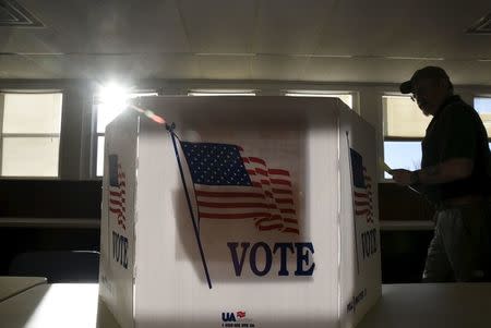 A voter heads to the booth to fill out his ballot at a polling site in Stillwater, Oklahoma, March 1, 2016. REUTERS/Nick Oxford/File Photo