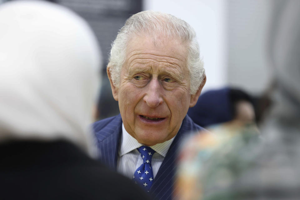 FILE - Britain's King Charles III joins members of the Sudanese community from across the United Kingdom, on the 20th anniversary of the conflict in Darfur, at a reception in London, Wednesday March 15, 2023. Unrest in France is tarnishing the sheen of King Charles III’s first overseas trip as monarch. Striking workers have refused to provide red carpets and critics are calling for the British king's visit to be canceled altogether amid pension reform protests. (Ian Vogler/Pool via AP, File)