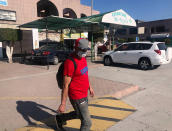 Jose Magana walks in Tijuana on Oct. 8, 2020, after being expelled from the U.S., for the eighth time since May. President Donald Trump’s reshaping of U.S. immigration policy may be most felt in his undoing of asylum. With immigration laws temporarily suspended at the border during the pandemic, people who enter the U.S. illegally are immediately “expelled” without even a piece of paper to record the incident. (AP Photo/Elliot Spagat)