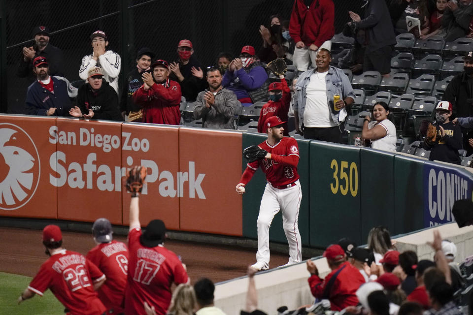 Fans cheer after Los Angeles Angels' Taylor Ward caught a fly ball hit by Tampa Bay Rays' Yandy Diaz during the sixth inning of a baseball game Thursday, May 6, 2021, in Anaheim, Calif. (AP Photo/Jae C. Hong)