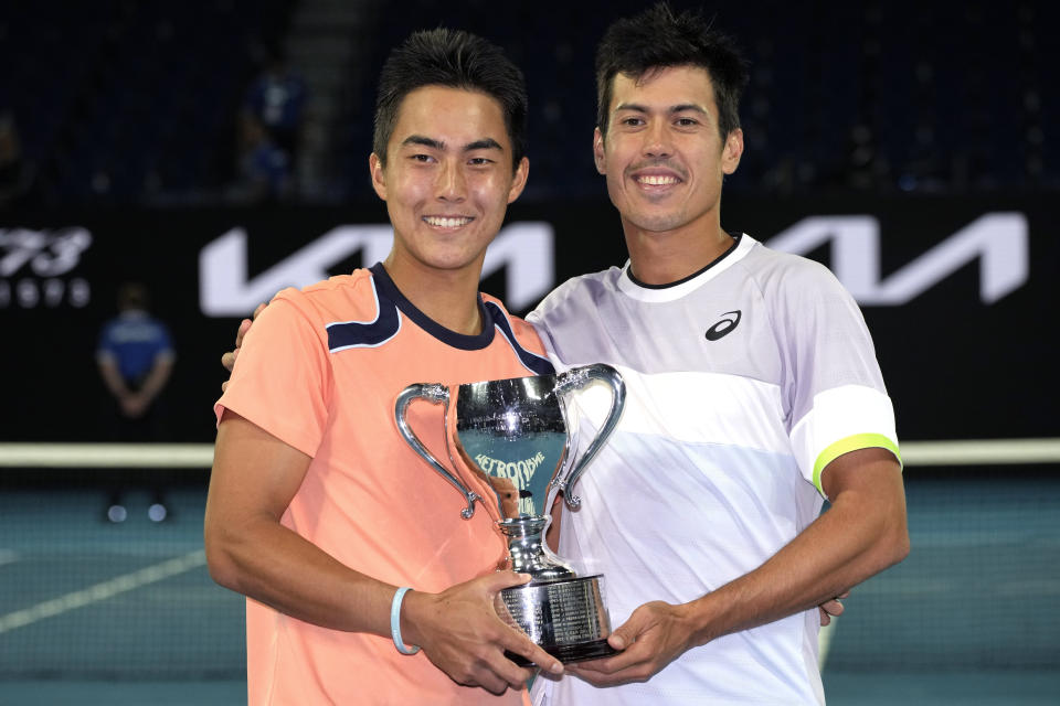 Rinky Hijikata, left, of Australia and compatriot Jason Kubler pose with their winners trophy after defeating Hugo Nys of Monaco and Jan Zielinski of Poland in the men's doubles final at the Australian Open tennis championship in Melbourne, Australia, Sunday, Jan. 29, 2023.. (AP Photo/Aaron Favila)