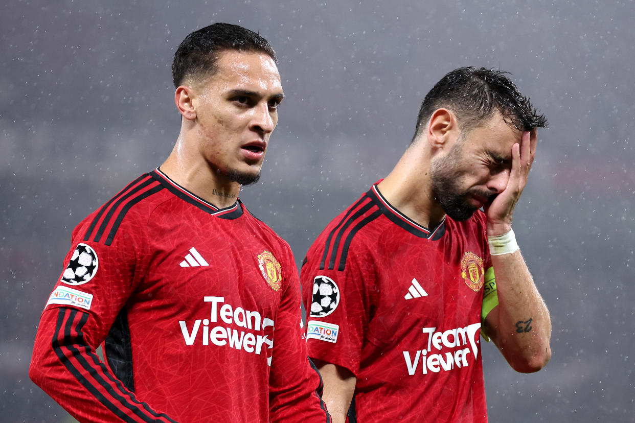 Manchester United's Antony and Bruno Fernandes look dejected following the team's defeat by Galatasaray in the UEFA Champions League.