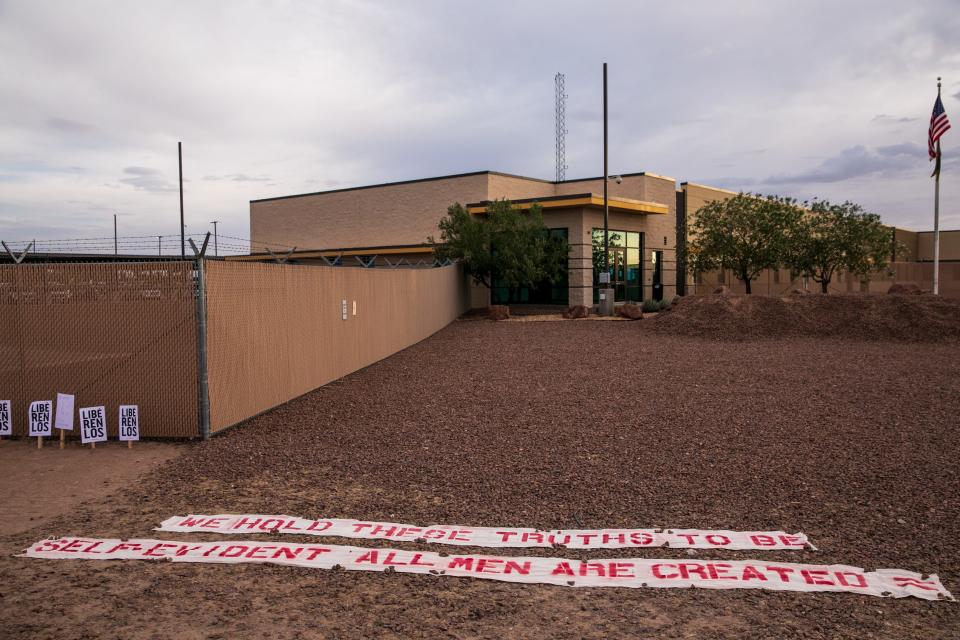 A banner with a portion of the Declaration of Independence made by Elizabeth Rudge from Seattle is displayed in front of the Clint, Texas, facility on the Fourth of July.