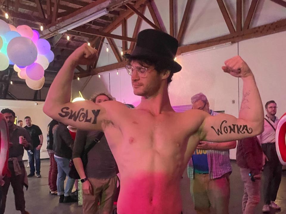 Willy Wonka’s self-described bodyguard “Swoly Wonka” poses for the camera at the Willy Wonka Experience in Downtown Los Angeles, California on 28 April. (Olivia Hebert)